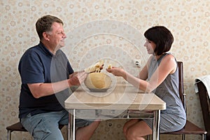 A happy married couple, a man and a woman, are having a fun conversation sitting