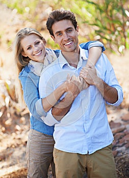 Happy, married couple and portrait with hug in nature, bonding together and love in city with commitment. People, smile