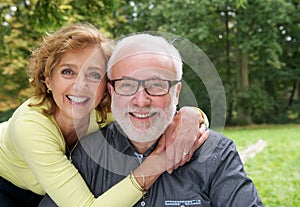 Happy married couple smiling together outdoors