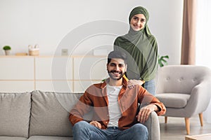 Happy Married Muslim Couple Posing At Home, Smiling To Camera