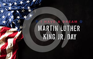 Happy Martin Luther King Day concept.  American flag againt black wooden background photo