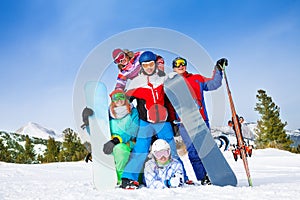 Happy mates with snowboards and skis