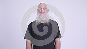 Happy mature bald bearded man relaxing with eyes closed