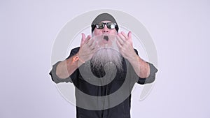Happy mature bearded hipster man giving flying kiss