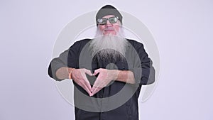 Happy mature bearded hipster man showing hand heart sign