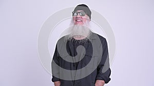Happy mature bearded hipster man smiling while thinking