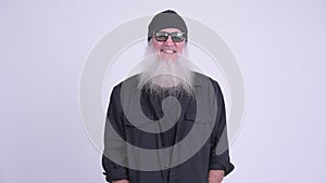 Happy mature bearded hipster man with sunglasses smiling