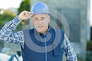 happy mature builder looking at camera