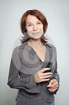 Happy mature business woman with cell phone