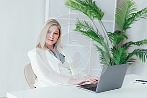 Happy mature business woman entrepreneur in office using laptop at work, smiling professional middle aged 40 years old