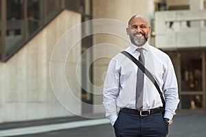 Happy mature businessman standing on street