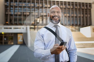 Happy mature businessman using phone