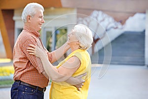 Happy mature couple dancing outdoors