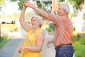 Happy mature couple dancing outdoors