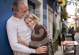 Happy Mature Couple Embracing And Laughing Standing On Street Outdoor