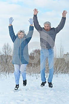 Happy mature couple jumping