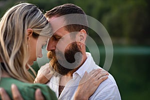 Happy mature couple in love hugging in nature.