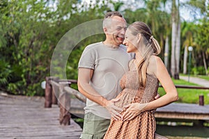 A happy, mature couple over 40, enjoying a leisurely walk in a park, their joy evident as they embrace the journey of