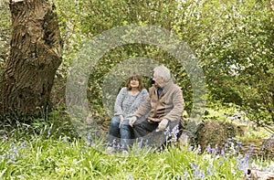Happy mature couple sitting outdoors