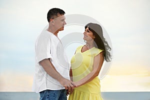 Happy mature couple spending time together on sea beach