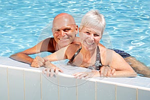 Happy mature couple in the swimming pool