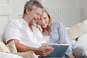 Happy Mature Couple With Tablet