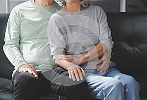 Happy mature couple using laptop at home