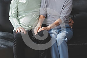 Happy mature couple using laptop at home