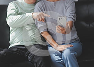 Happy mature couple using laptop at home