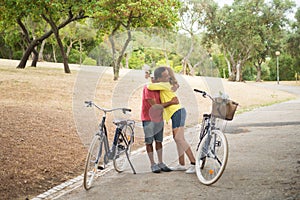 Happy mature cyclists dating in autumn park