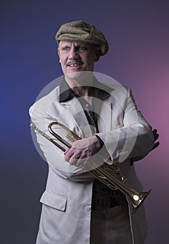 Happy mature jazz man with a trumpet