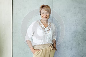 Happy mature lady portrait. Senior woman smiling indoor