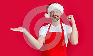 happy mature man in red houseman apron and christmas santa hat