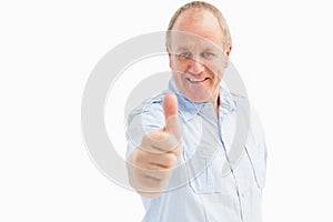 Happy mature man showing thumbs up to camera