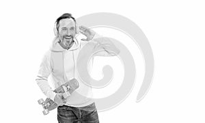 happy mature man skateboarder listen music wearing headphones hold penny skateboard, streetwise. photo