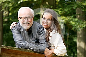 Happy mature man smiling with young woman