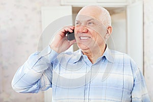 Happy mature man speaks by phone