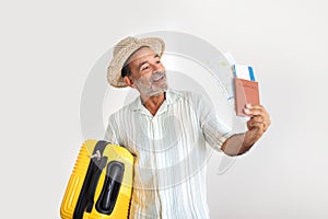 Happy Mature Man With Travel Suitcase Showing Tickets, Gray Studio