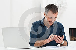 Happy Mature Man Using Cellphone