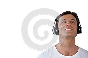 Happy mature man wearing headphones looking up