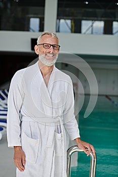 happy mature man in white robe