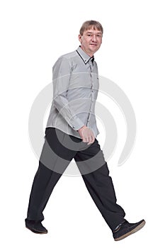 happy mature man in white shirt striding forward.