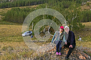 happy mature married couple traveling through the Ural mountains