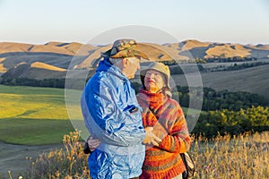 happy mature married couple traveling through the Ural mountains