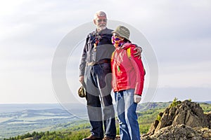 happy mature married couple traveling through the Ural mountains