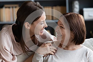 Happy mature mother and adult daughter enjoying tender moment