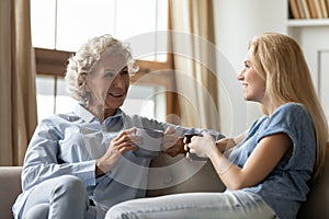 Happy mature mother and adult daughter rest at home