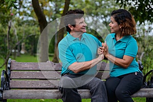 Happy mature multi ethnic married couple together and in love at the park