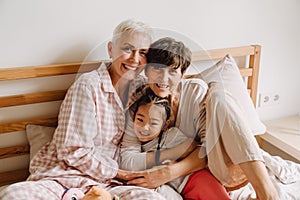 Happy mature same sex couple with adopted asian little girl