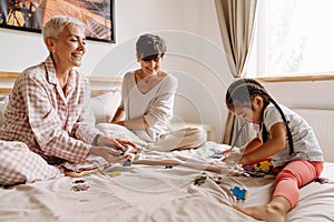 Happy mature same sex couple plying with asian little girl